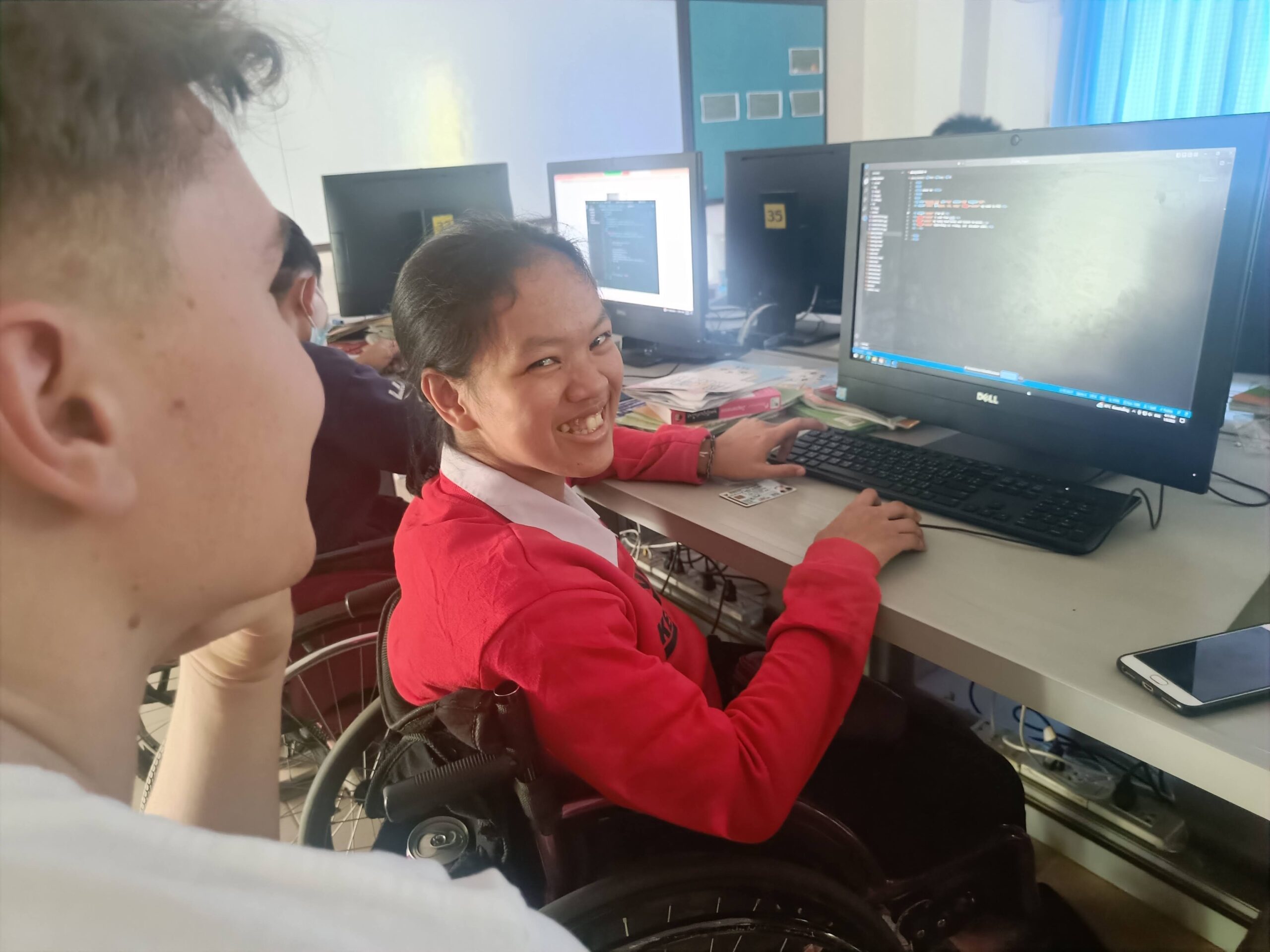 Happy disabled girl learning it coding skills