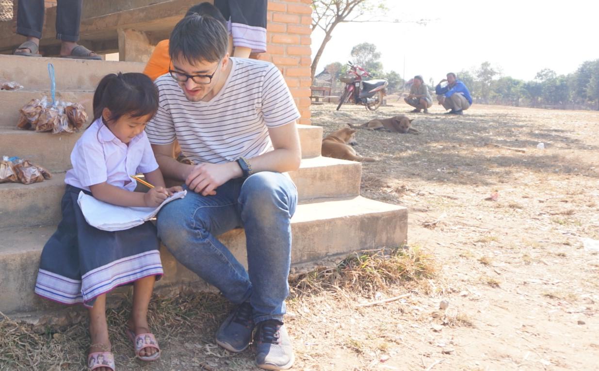 Volunteer teaching village kids